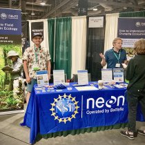 Ryan McClure behind the NEON exhibit booth at ESA 2024