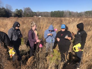 Interns setting transects in the field