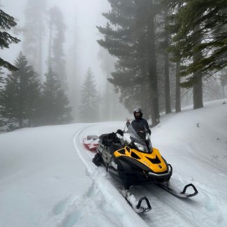 field tech on a snowmobile